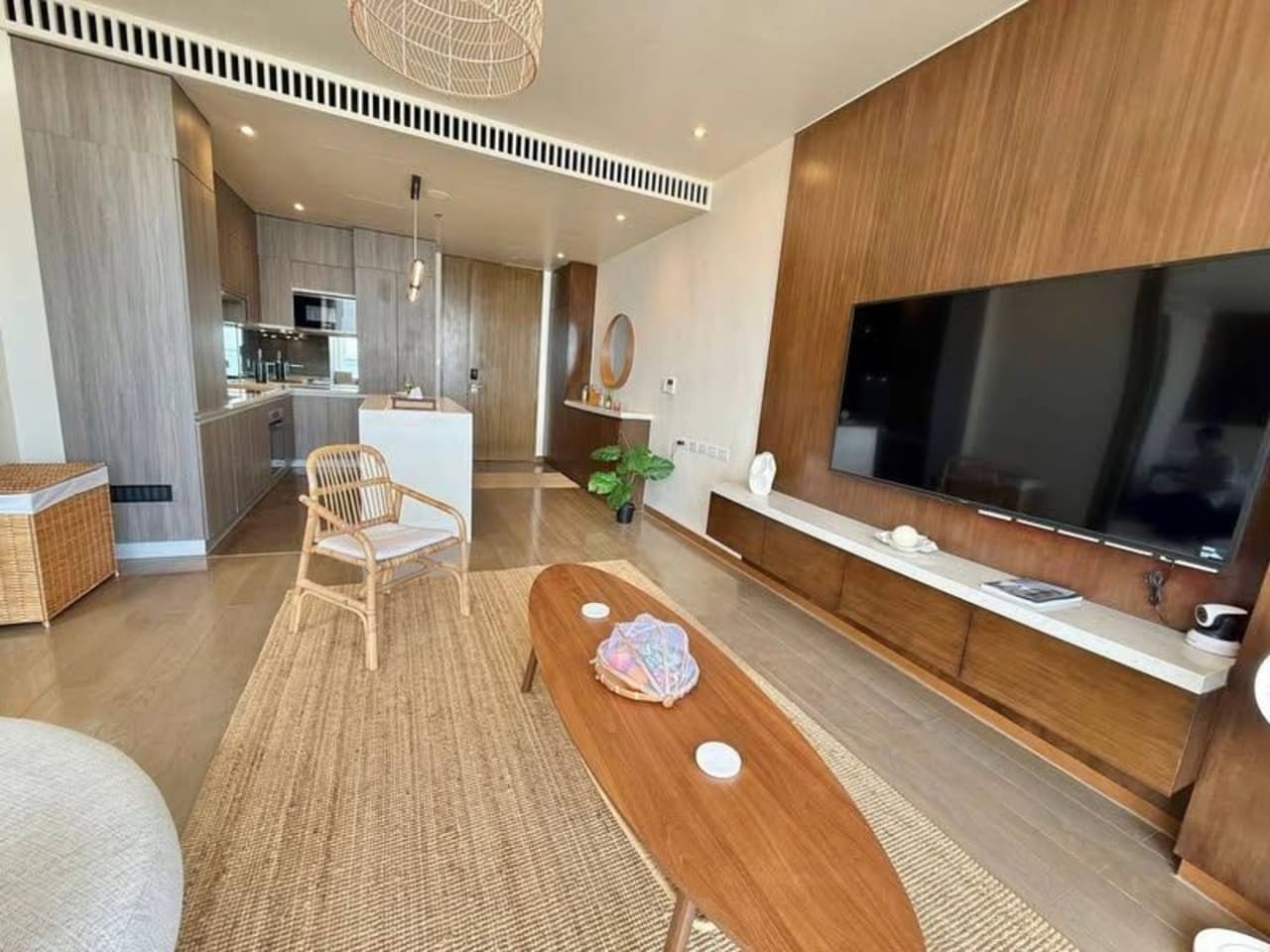 Open-plan living and dining area with television, dining table, and modern furnishings in a luxury sea-view condo at Sheraton Cebu Mactan Resort.