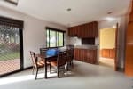 Kitchen view with brown table set and kitchen counter in House & Lot for Sale in Liloan, Cebu