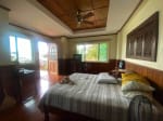 Bedroom interior with windows in waterfront house for sale in Mactan Cebu