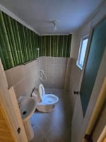 Renovated bathroom with toilet and sink in 2-bedroom townhouse for sale in Consolacion Cebu
