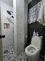 Modern bathroom with toilet and black wall tiles house and lot for sale in Tisa
