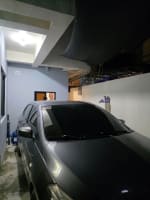 Black car in a garage in house and lot for sale in Tisa