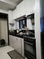 Kitchen with white cabinets and stove in house and lot for sale in Tisa