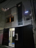 Outside view with black gate and view of the whole house house and lot for sale in Tisa