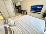 Studio bedroom with double bed, smart TV, dining area and kitchen at JTower Residences Mandaue City