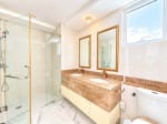 Bathroom with glass-enclosed shower and double sink marble vanity at Marco Polo Residences, Cebu City