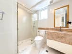 Second bathroom with frameless glass shower, wall-hung vanity and bidet toilet in Marco Polo Residences condo