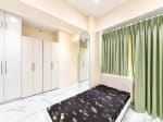 Bedroom with floor-to-ceiling white closets, green drapes and single bed in Cebu City luxury condo