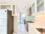 Galley kitchen with Samsung refrigerator, stove and laundry area beside a window with mountain view