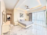 Master bedroom with tufted wall panels, vanity set and corner windows at Marco Polo Residences, Cebu City