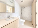 Modern condo bathroom with vanity sink and toilet in a Mandani Bay Tower 2 loft unit