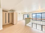 Upper-level loft room with built-in wardrobe and wood flooring at Mandani Bay Tower 2, Mandaue