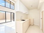 White-cabinet kitchenette with sink and natural light in a 104 sqm Mandani Bay condo for sale