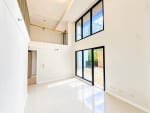Double-height condo living area with large sliding glass doors at Mandani Bay, Mandaue City