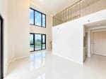 1. Wide view of the open-plan double-height interior of a 2-bedroom loft condo for sale at Mandani Bay, Mandaue City