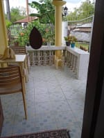 Tiled front porch with outdoor seating at a house for sale in Catarman, Cordova, Cebu.