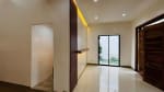 Open living space with sliding glass doors, polished flooring, and modern recessed lighting in a tropical bungalow in Yati, Liloan.