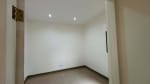 Small empty bedroom with white walls, tiled flooring, and a doorway in a modern bungalow at St. Joseph Heights Subdivision, Yati, Cebu.