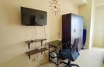 Wall-mounted television, floating shelves, and computer desk with office chair inside a fully furnished studio condo at Avida Riala Tower 3, Cebu IT Park.