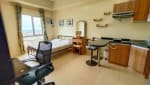 Studio condo interior with dining table, office chair, bed, and compact kitchen at Avida Riala Tower 3 in Cebu IT Park.