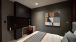 Bedroom with gray bedding, upholstered headboard, abstract wall art, bedside furniture, and dark accent walls in a contemporary Cebu City home.