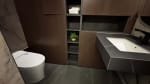 Modern bathroom with a wall-mounted toilet, white countertop basin, dark cabinetry, and built-in shelving in a three-storey house for sale in Cebu City.