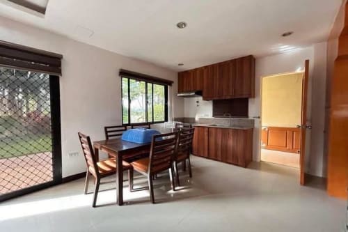 Kitchen view with brown table set and kitchen counter in House & Lot for Sale in Liloan, Cebu