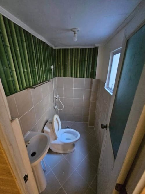 Renovated bathroom with toilet and sink in 2-bedroom townhouse for sale in Consolacion Cebu