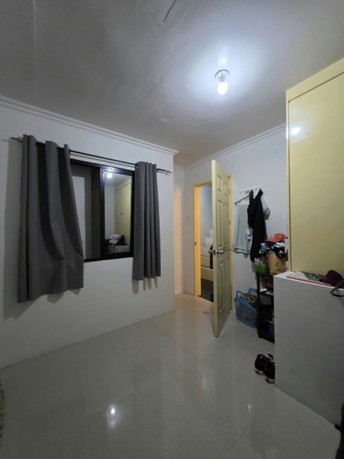 Inside a bedroom with black curtains house and lot for sale in Tisa