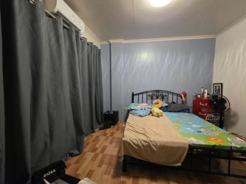 Bedroom with brown floor and black curtain house and lot for sale in Tisa