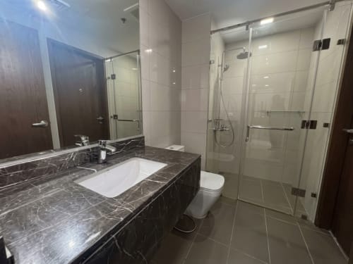 Modern bathroom with glass shower enclosure in fully furnished 1-bedroom condo at The Alcoves Cebu