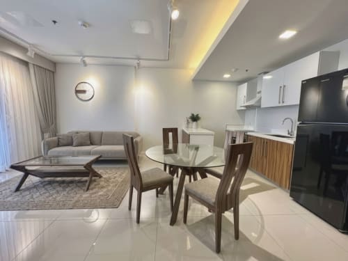 Fully furnished 1-bedroom condo for sale at The Alcoves Cebu with living room, dining area and modern kitchen