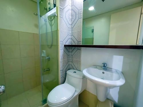 Bathroom with glass shower enclosure and vanity sink in fully furnished studio condo at Avida Towers 2 Cebu IT Park