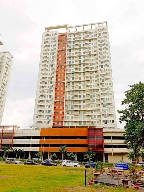 Avida Towers 2 condominium building exterior in Cebu IT Park with landscaped grounds and parking area