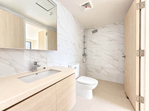 Modern condo bathroom with vanity sink and toilet in a Mandani Bay Tower 2 loft unit