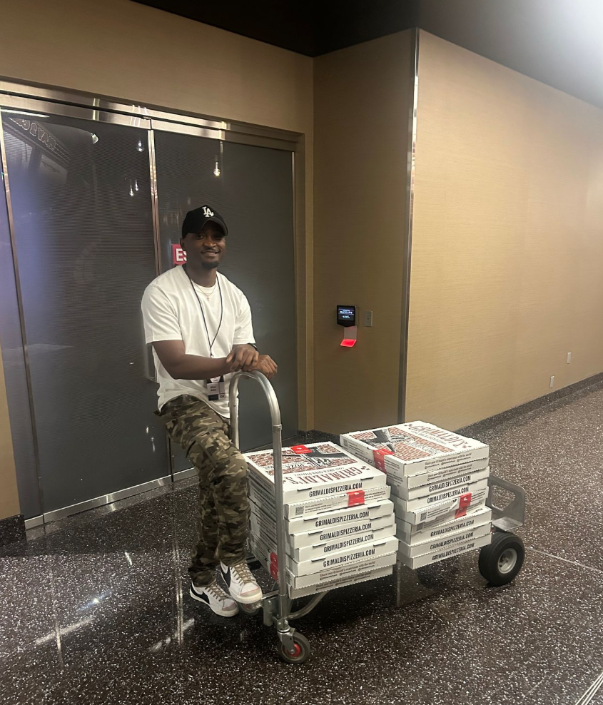 Khim Aday delivers pizza to Press Room