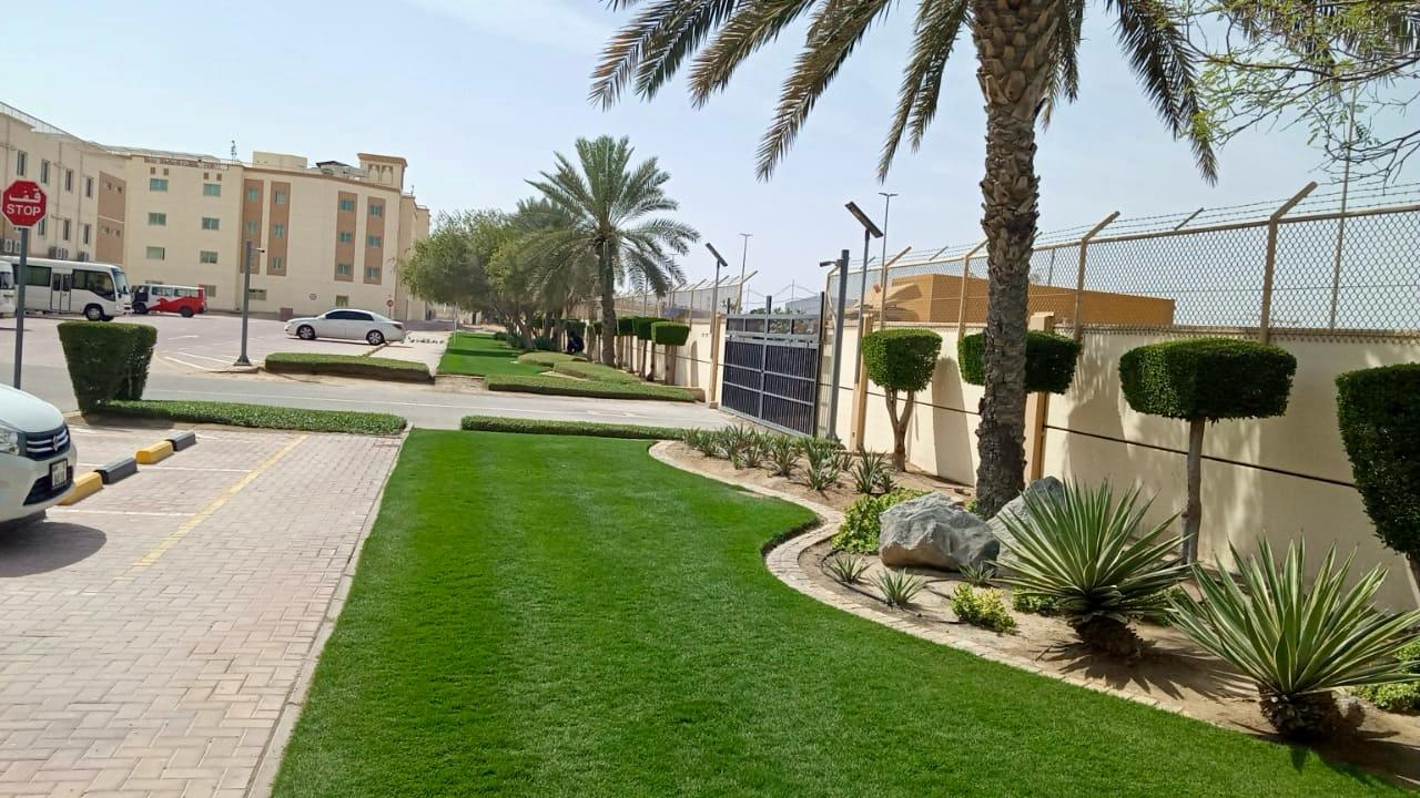 Landscape installation and hardscape works at Labour Village 2 Dubai Industrial City including interlock paving, pergola, and seating areas - Photo 11