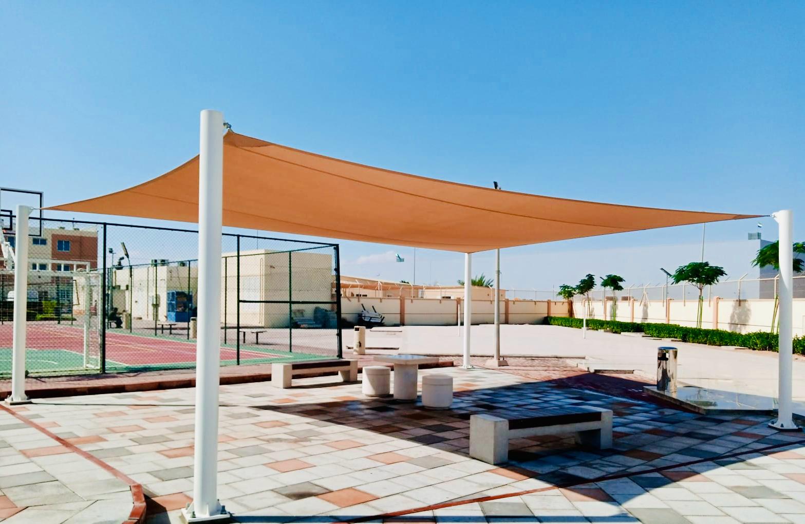 Landscape installation and hardscape works at Labour Village 2 Dubai Industrial City including interlock paving, pergola, and seating areas - Photo 6