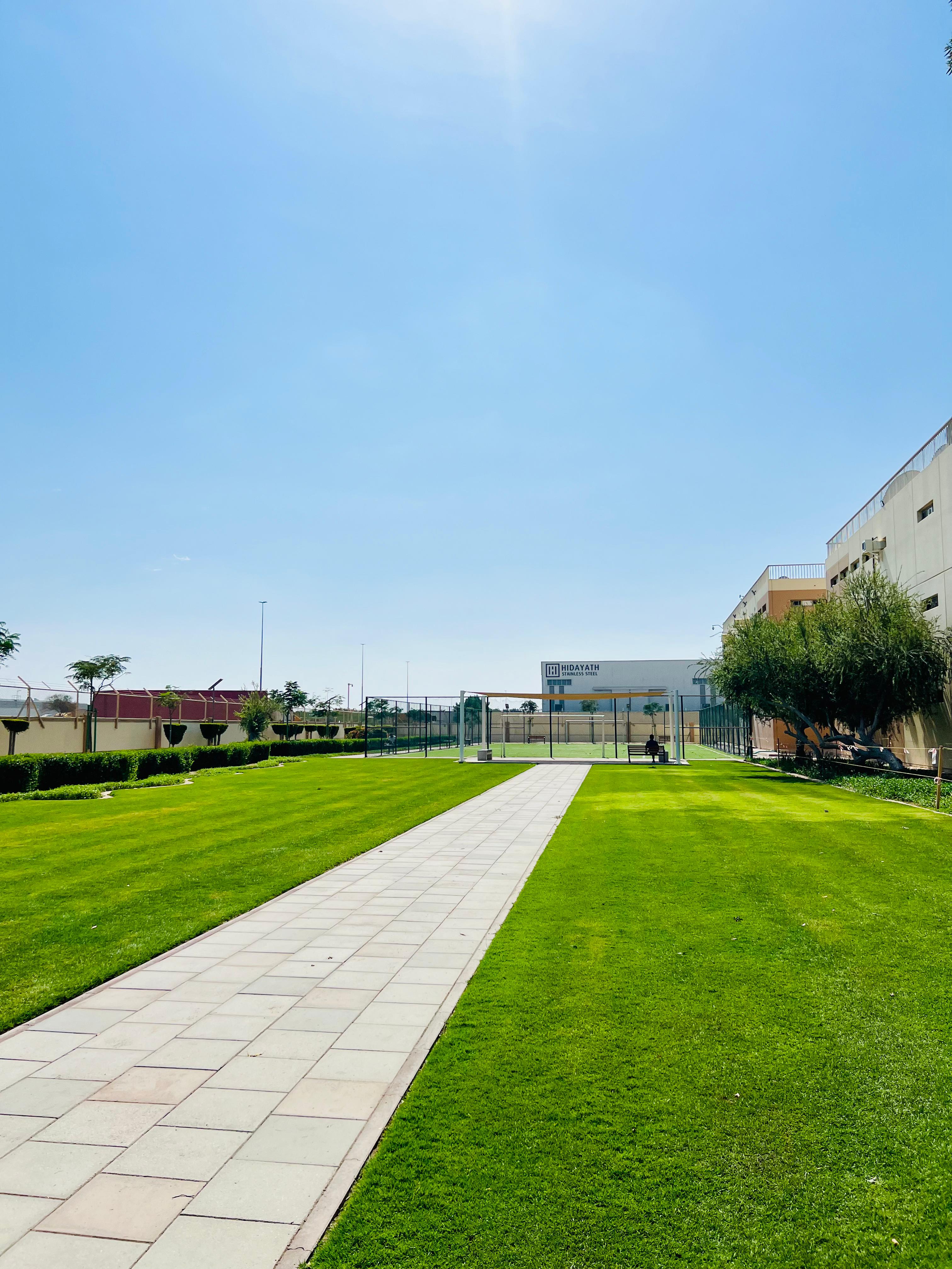 Landscape installation and hardscape works at Labour Village 2 Dubai Industrial City including interlock paving, pergola, and seating areas - Photo 5