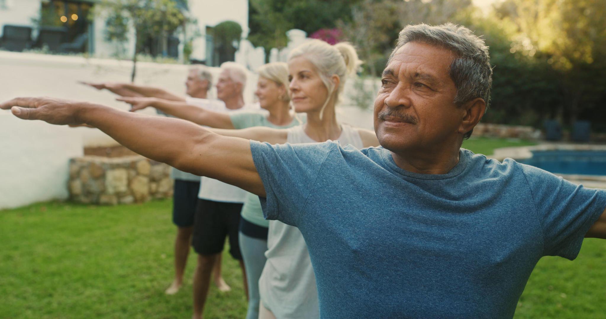 Shot of a group of seniors practicing yoga together outside 