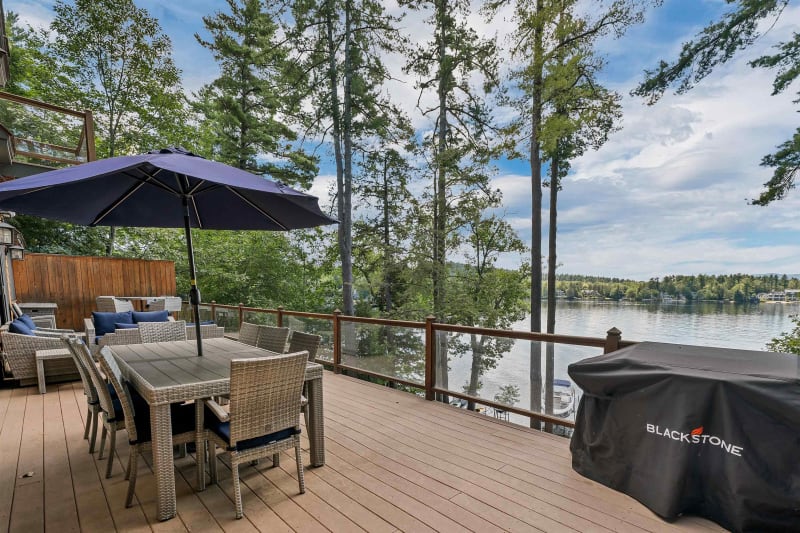 Expansive deck with lake views and outdoor furniture
