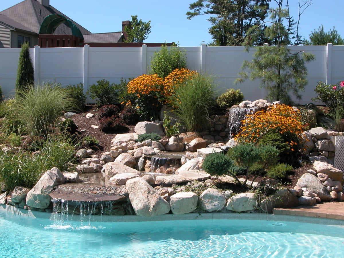 Custom stone waterfall and garden pool built by Burns Landscaping