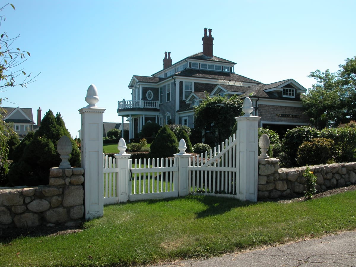 Landscaped garden with stone wall and gate, by Burns Landscaping