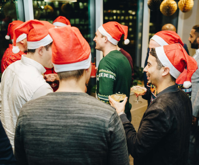A group of colleagues wearing santa hats and drinking cocktails in one of Uncommon's London event spaces