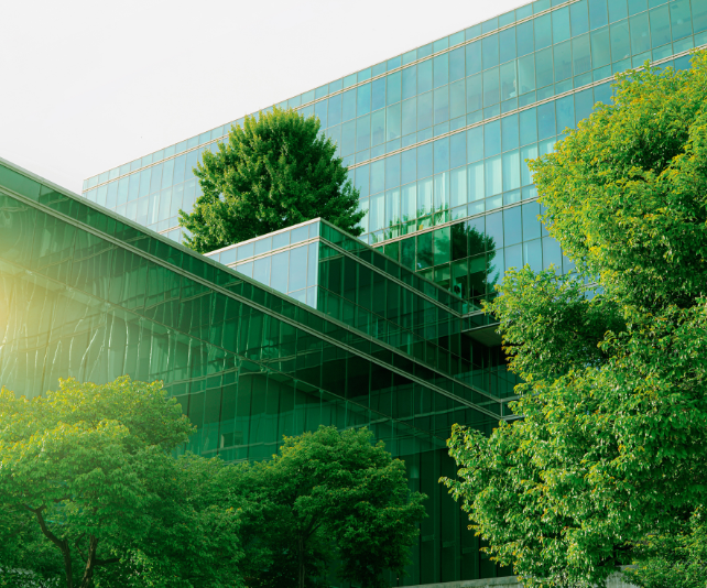 Glass-fronted office building surrounded by trees