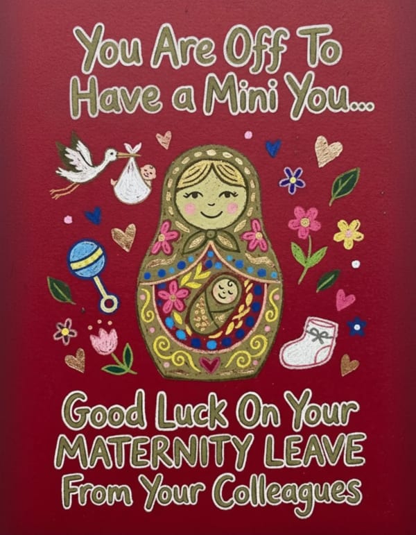 Maternity card with nesting doll and playful baby-themed illustrations.
