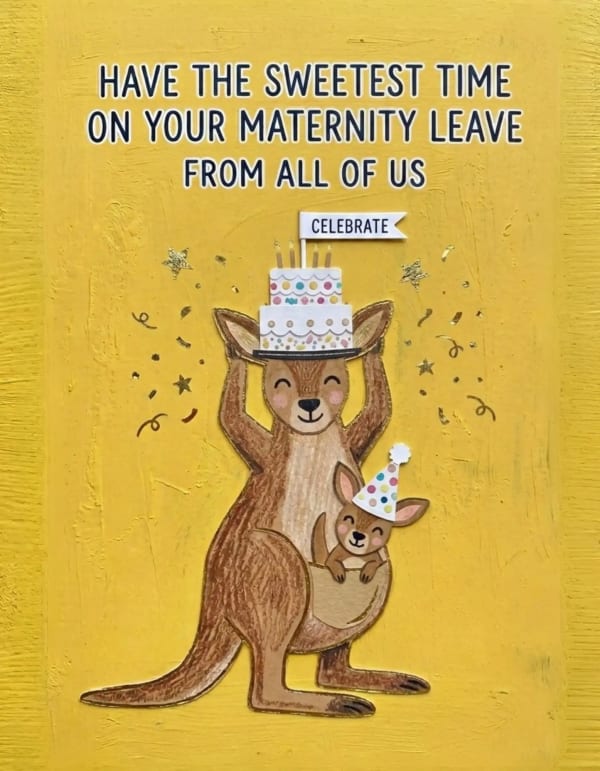 Kangaroo with joey holding a cake, surrounded by festive decorations.