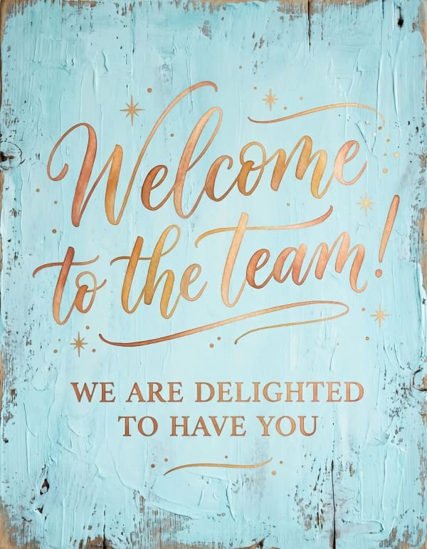 Welcome card with elegant gold lettering on pastel blue background.