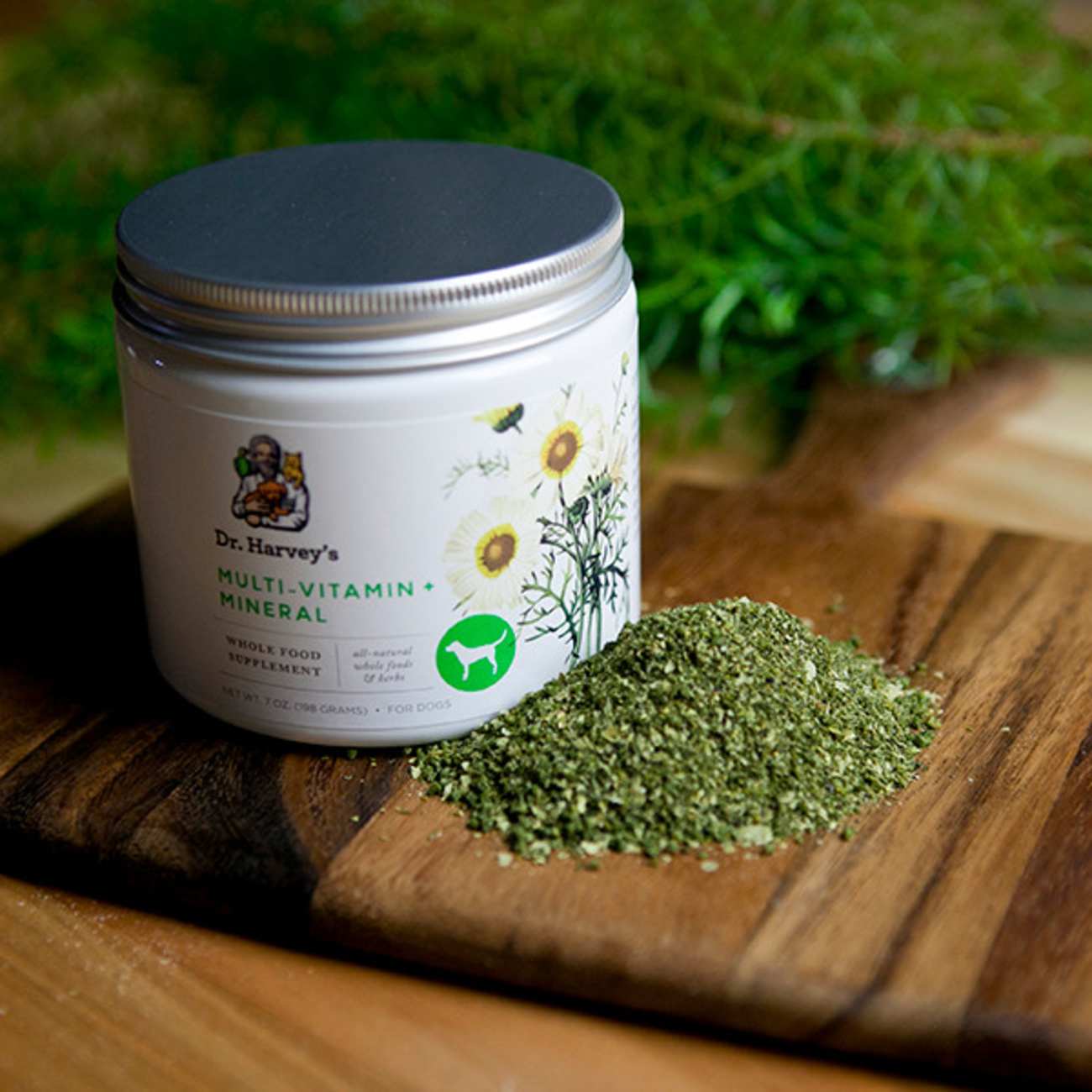 A white jar with green substance on a wooden surface