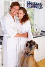 A man and woman in white lab coats with a dog